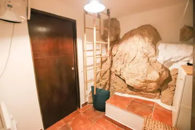a room with a rock on the wall next to a door at ROCHE-Rock in the heart of the Old Town in Villefranche-sur-Mer
