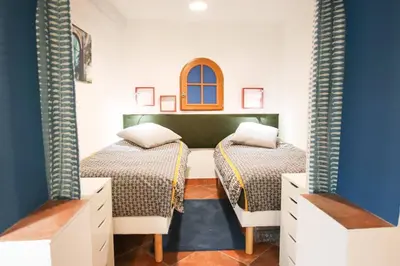 two beds in a room with blue and white walls at ROCHE-Rock in the heart of the Old Town in Villefranche-sur-Mer