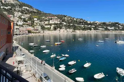 a group of boats in a harbor on a body of water at ROCHE-Rock in the heart of the Old Town in Villefranche-sur-Mer