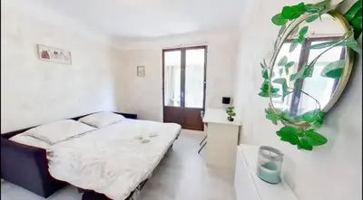 a bedroom with a bed and a mirror on the wall at Nice collines in La Trinité