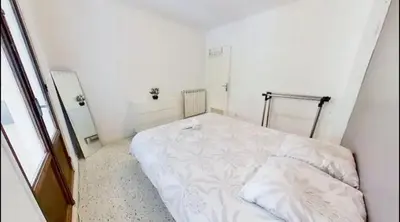a bedroom with a white bed in a room at Nice collines in La Trinité