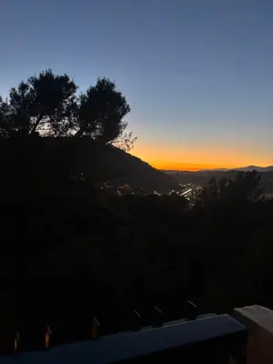 a sunset on a hill with trees on it at Nice collines in La Trinité