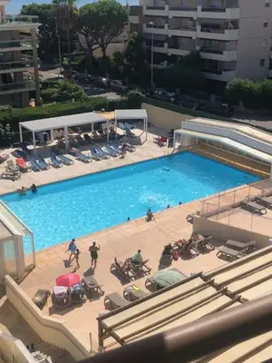 an overhead view of a large swimming pool with people in chairs at Héliotel Marine in Saint-Laurent-du-Var