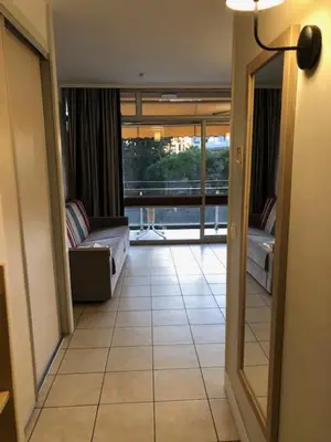 a hallway with a view of a living room at Héliotel Marine in Saint-Laurent-du-Var