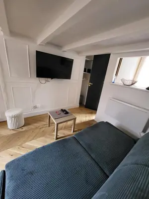 a bedroom with a bed and a flat screen tv at Studio Cosy Mezzanine 2-4p Carré d'Or in Nice
