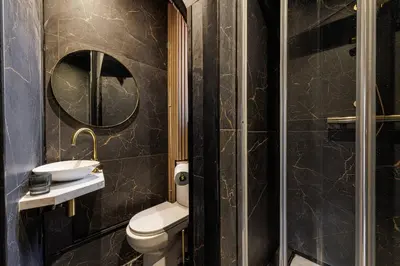 a bathroom with a toilet and a sink and a mirror at Studio Cosy Mezzanine 2-4p Carré d'Or in Nice