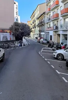 an empty parking lot with cars parked next to buildings at Studio Lumiere Nice Center in Nice
