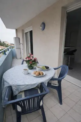 a table with a plate of food on a balcony at Cocoon au calme, proche mer et centre ville in Nice
