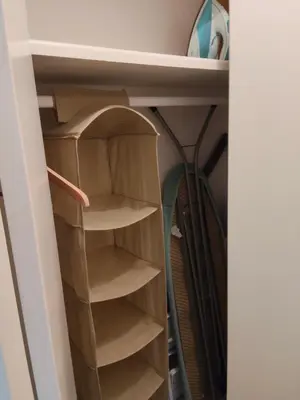 a closet with wooden shelves in a room at Good studio in Nice