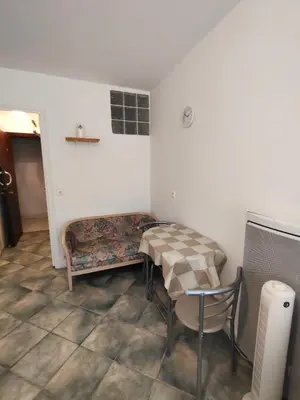 a room with a bed and a table and a chair at Good studio in Nice