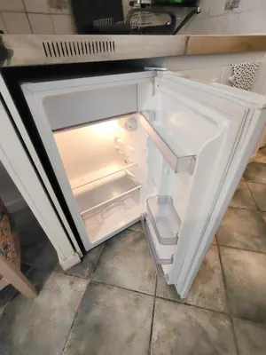 an empty refrigerator with its door open in a kitchen at Good studio in Nice