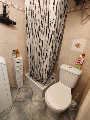 a bathroom with a toilet and a shower curtain at Good studio in Nice
