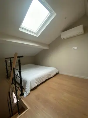 a bedroom with a bed and a window at Duplex cosy sur Nice Libération in Nice