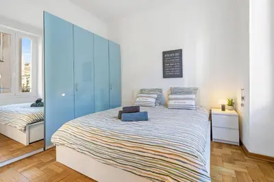 a bedroom with a large bed with a blue cabinet at Nice Renting - GRIMALDI - Golden Square Best Location Fully Equiped in Nice