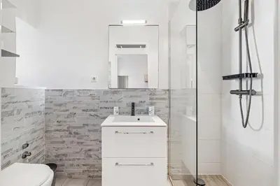 a white bathroom with a sink and a shower at Nice Renting - GRIMALDI - Golden Square Best Location Fully Equiped in Nice