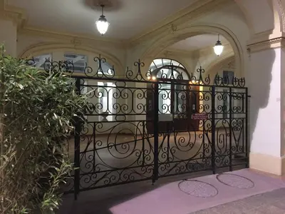 a black iron gate in a building with an arch at Perfect Location downtown - elegant apartment in Nice