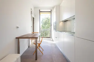 a small kitchen with a table and a window at Perfect Location downtown - elegant apartment in Nice