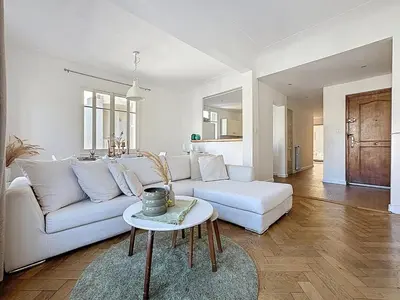 a living room with a white couch and a table at Large 2 bedroom apartment, Close to Promenade des Anglais in Nice