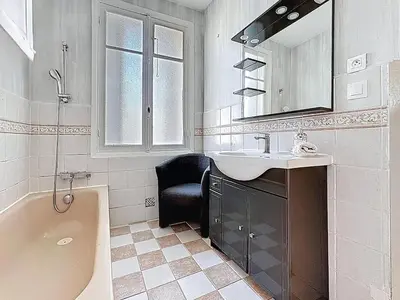 a bathroom with a tub and a sink and a mirror at Large 2 bedroom apartment, Close to Promenade des Anglais in Nice