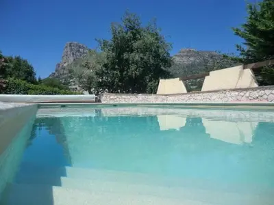 a swimming pool with blue water and a skate park at Nice Petite maison mitoyenne avec piscine in La Gaude