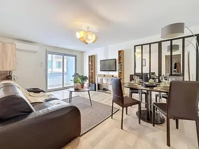 a living room with a couch and a table at One bedroom apartment with terrace , Port de Nice , ideal location in Nice
