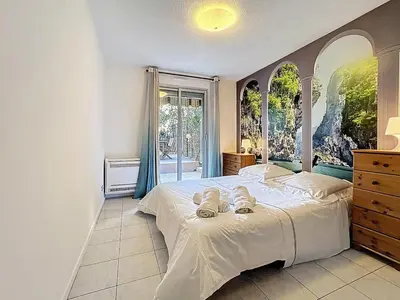 a bedroom with a large bed and a window at One bedroom apartment with terrace , Port de Nice , ideal location in Nice