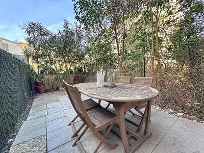 a wooden table and chairs on a patio at One bedroom apartment with terrace , Port de Nice , ideal location in Nice