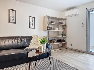 a living room with a leather couch and a table at One bedroom apartment with terrace , Port de Nice , ideal location in Nice