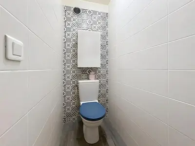 a bathroom with a toilet with a blue seat at One bedroom apartment with terrace , Port de Nice , ideal location in Nice