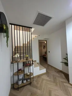 a hallway with a staircase in a home with white walls at La costière in Nice