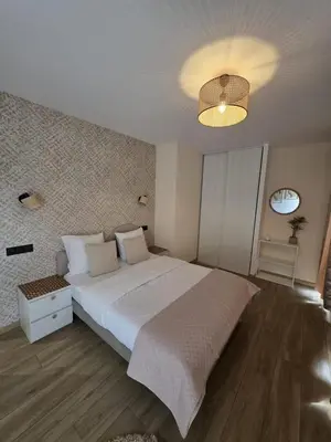 a bedroom with a large white bed and a chandelier at La costière in Nice
