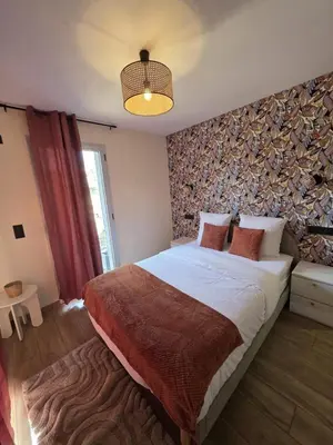a bedroom with a large bed in a room with a wall at La costière in Nice