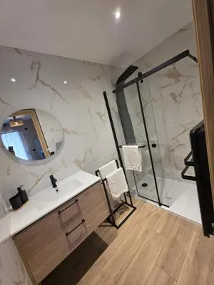 a bathroom with a sink and a shower with a mirror at La costière in Nice