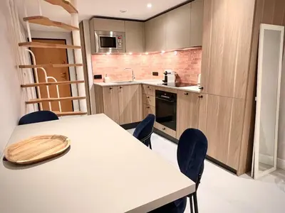a kitchen with a table and chairs in a room at Superbe duplex proche cours Saleya in Nice