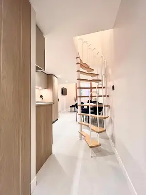 a hallway with a spiral staircase in a house at Superbe duplex proche cours Saleya in Nice