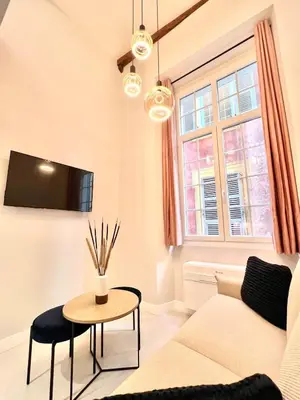 a living room with a couch and a table at Superbe duplex proche cours Saleya in Nice