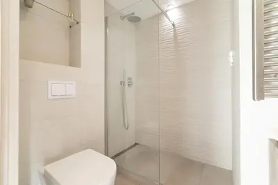 a bathroom with a glass shower with a toilet at Maison Bianchi - Studio on avenue Jean Medecin in Nice