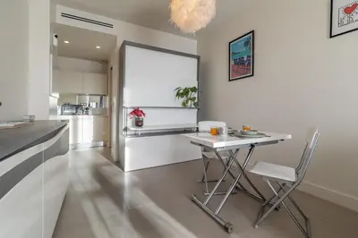 a kitchen with a table and chairs in a room at Maison Bianchi - Studio on avenue Jean Medecin in Nice