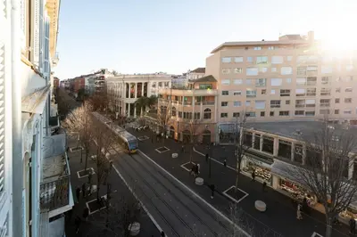 a view of a city with a train on the tracks at Maison Bianchi - Studio on avenue Jean Medecin in Nice