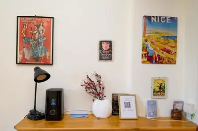 a desk with a speaker and pictures on a wall at LX196 Studio mezzanine balcon Tram plage à pied in Nice