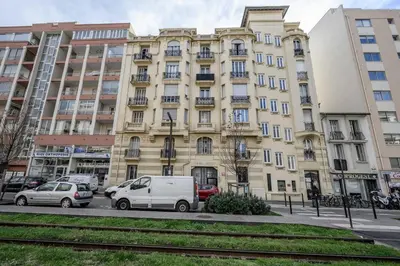 a large building with cars parked in front of it at LX196 Studio mezzanine balcon Tram plage à pied in Nice