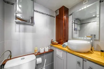 a bathroom with a white sink and a mirror at LX196 Studio mezzanine balcon Tram plage à pied in Nice