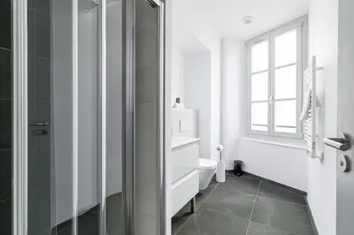 a bathroom with a toilet and a glass shower at Charming City Center Studio 402 in Nice