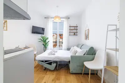a living room with a couch and a table at Charming City Center Studio 402 in Nice