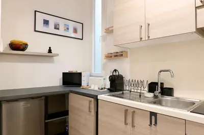 a kitchen with a sink and a counter top at Quiétude - Studio calme avec vue jardin en hyper centre de Nice in Nice