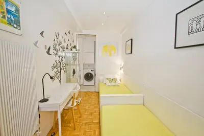 a hallway with a yellow rug on the floor and a desk at Le Copacabana Riviera in Nice