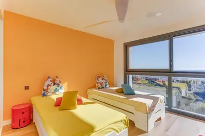 two beds in a room with a window at Villa Alba VI4498 by Riviera Holiday Homes in Nice