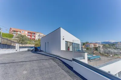 a white building on the roof of a building at Villa Alba VI4498 by Riviera Holiday Homes in Nice