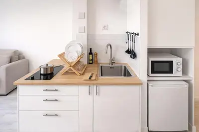 a small kitchen with a sink and a microwave at Le Valrose - Calme & Terrasse in Nice