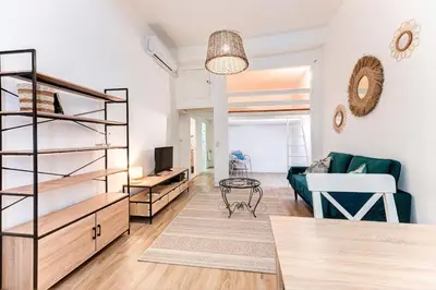 a living room with a couch and a table at Vieille Ville - parking, 5 pers, AC, WIFI in Nice